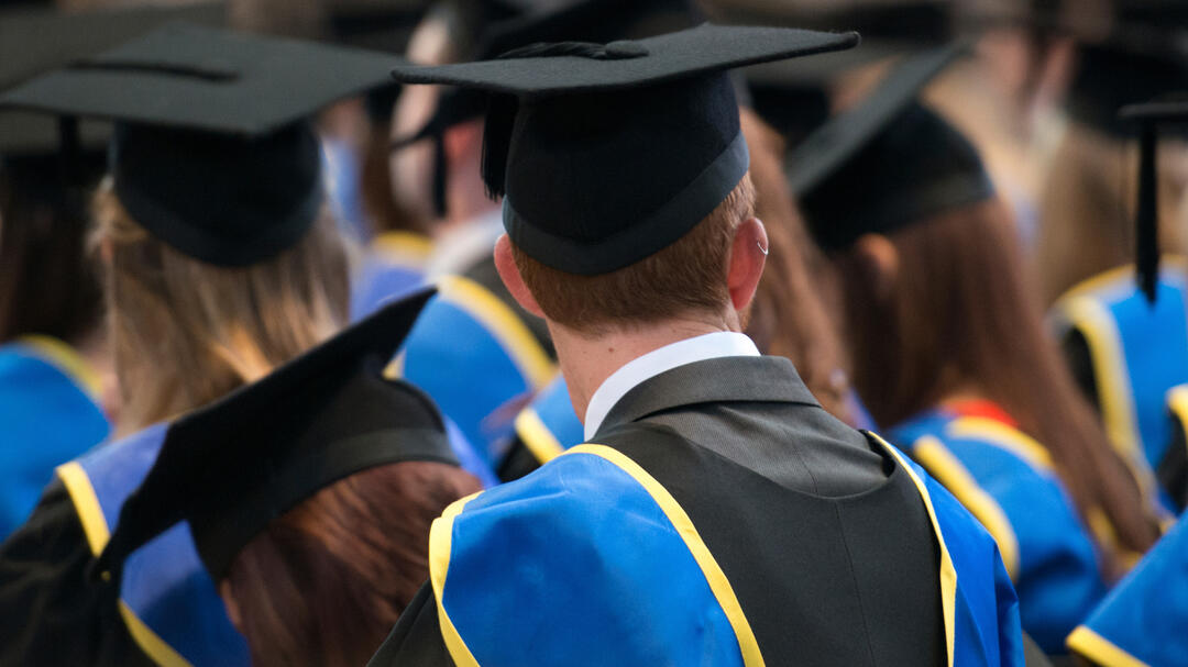 Lincoln, UK, September 10, 2014. Students sit in a row at their university graduation ceremony